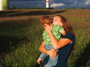 Older girl holding boy in her arms